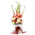 6 Gladioli, 10 Carnations and 4 Gerberas with White Paper Packing by FNP